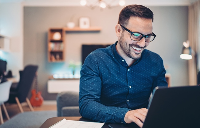 Young man working at home in the evening