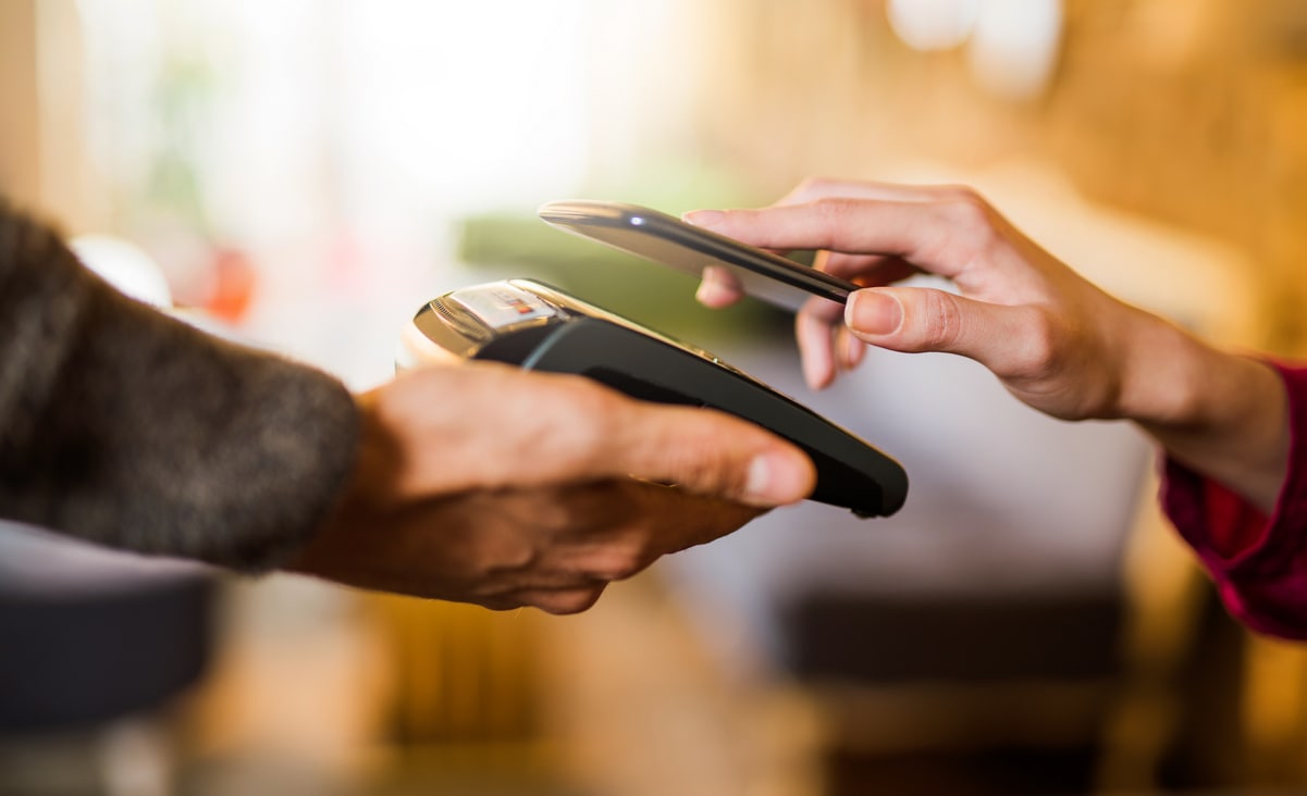 Contactless payment using a smart phone hand close up.