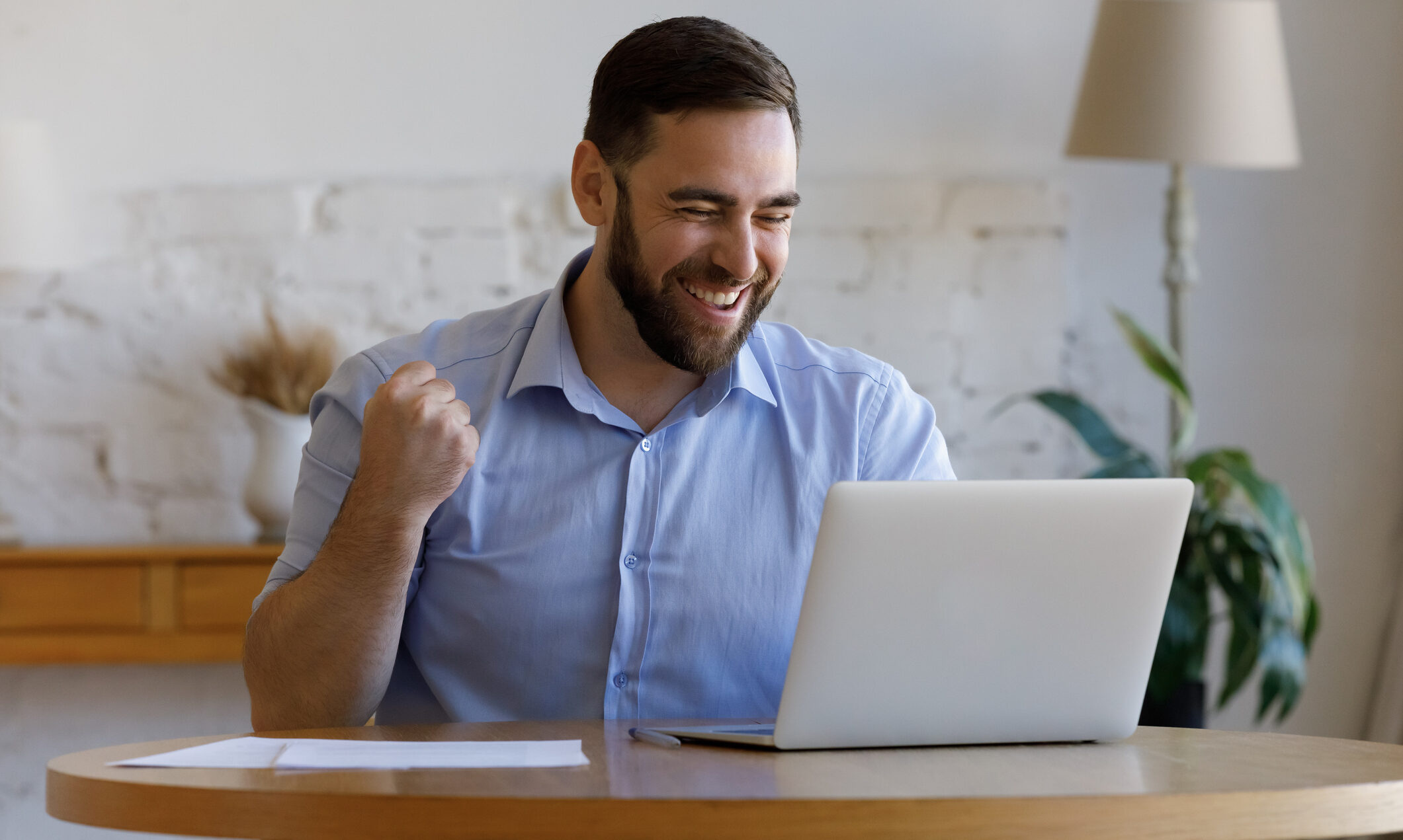Excited happy guy getting good news, looking at laptop display