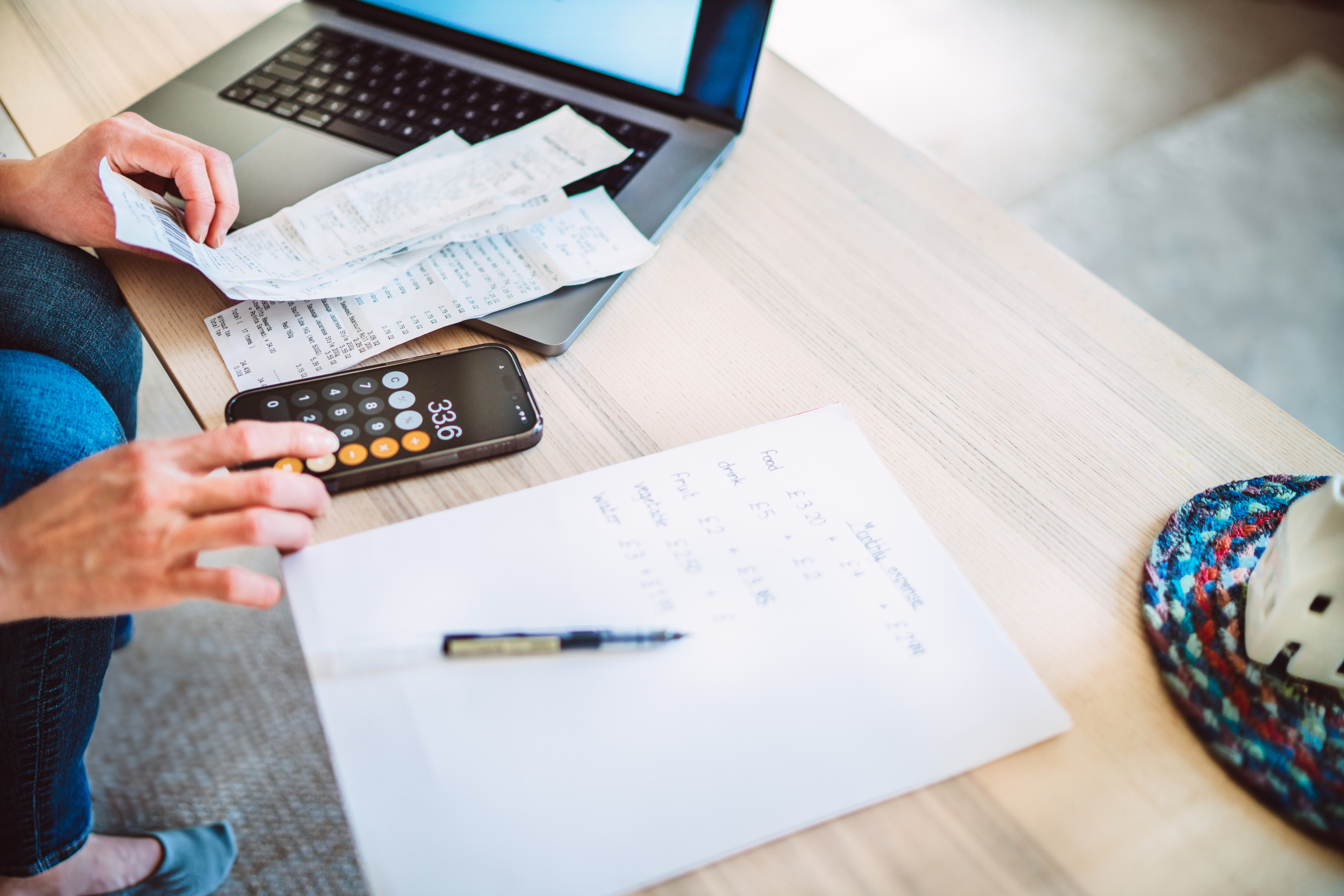 Young woman managing home budget with digital tools at home.