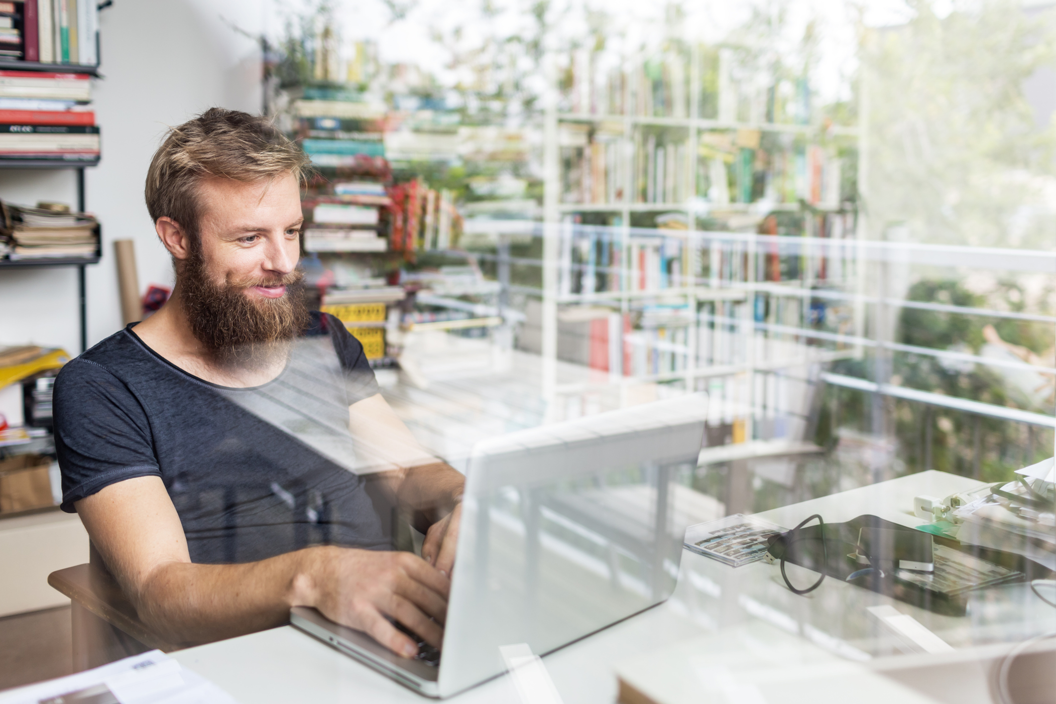 Young Bearded Man Working At Home Office